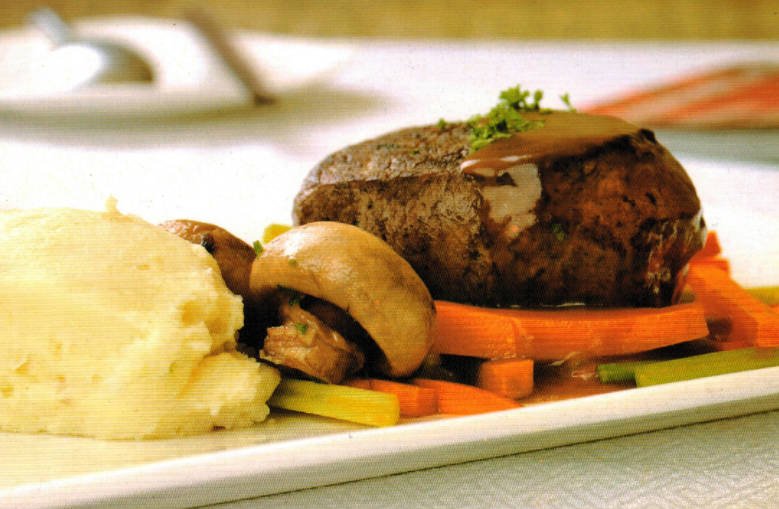 Pan-seared steak served with mashed potatoes and herb-infused mushrooms.